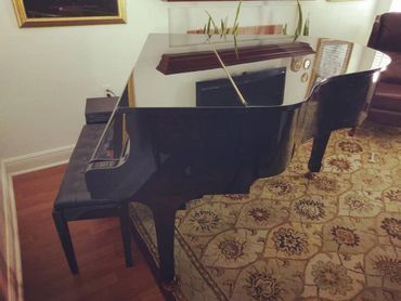 Side View of Black Baby Grand Piano— Summerfield, FL — Florida Piano Services. LLC
