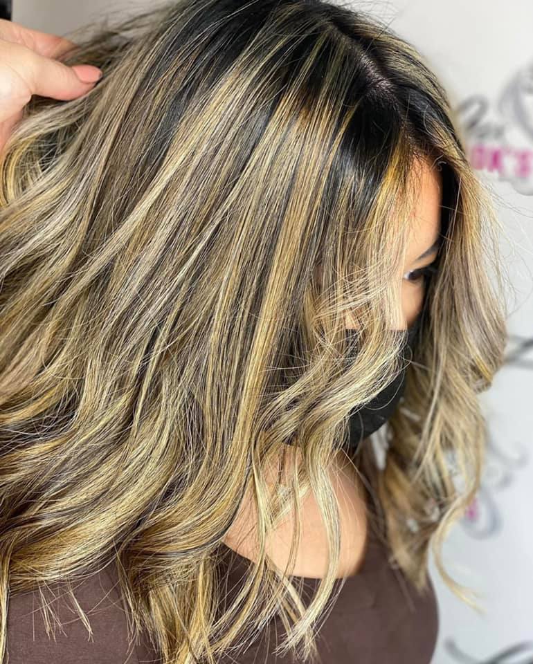 a woman with long blonde hair is wearing a mask .