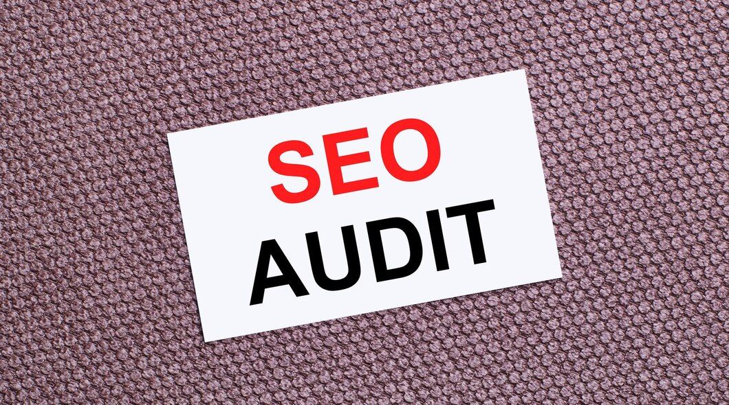 Photo on a brown background, a white rectangular card with the text seo audit