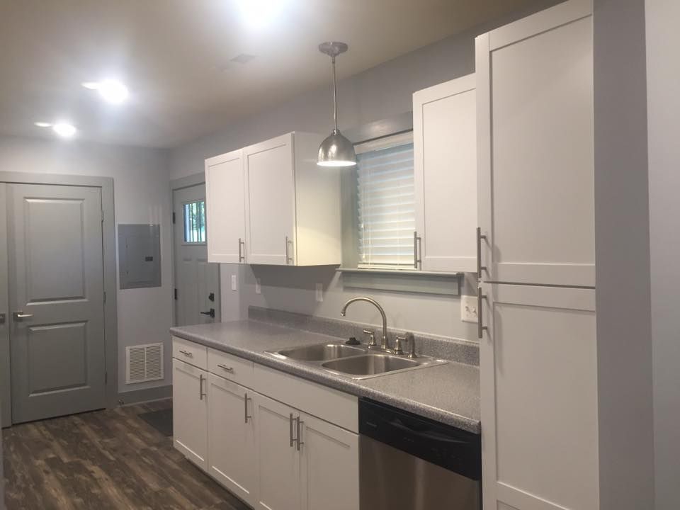 Kitchen with white cabinets, stainless steel appliances, and gray countertop.