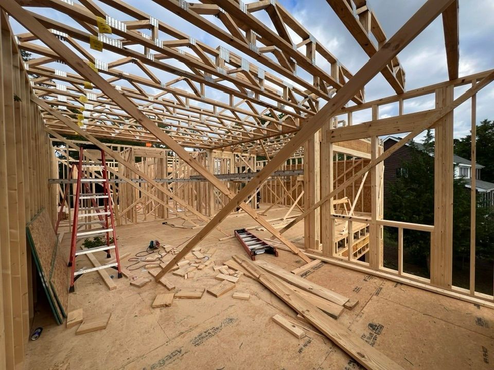 A large wooden structure under construction with a ladder in the middle.