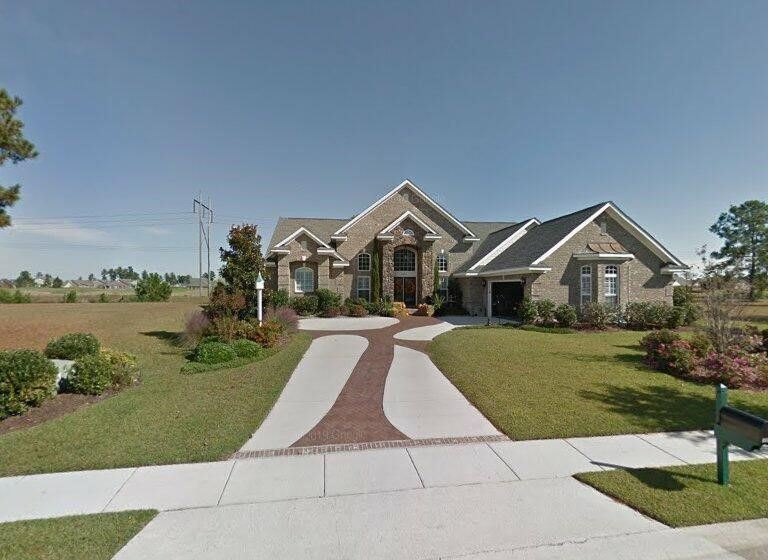 A large house with a driveway leading to it