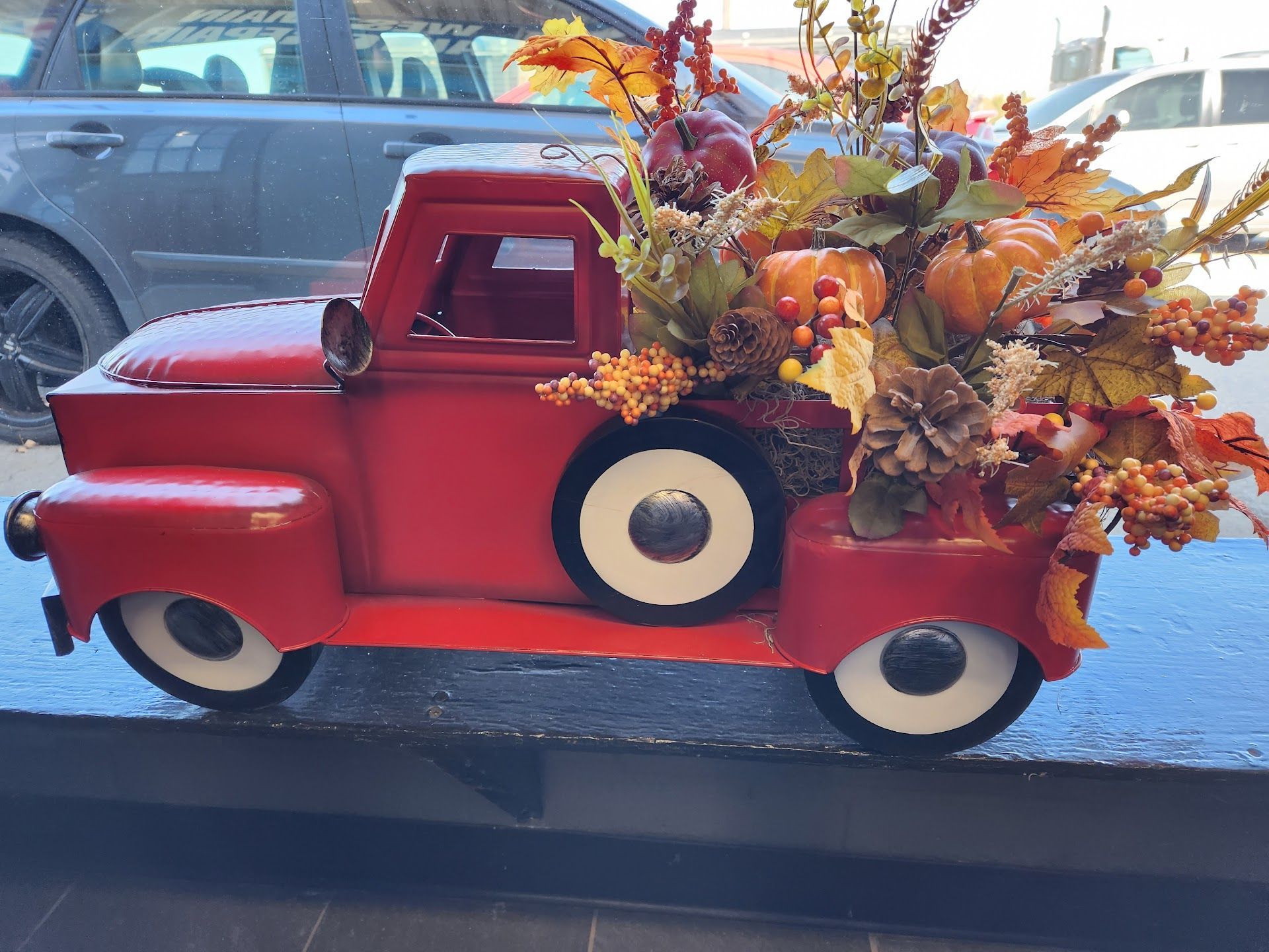 Red metal pickup truck decoration | West Main Auto Repair