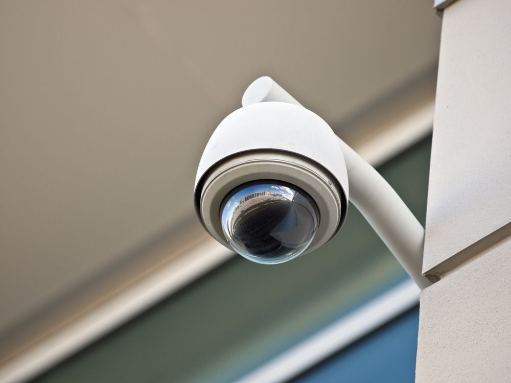 Security Camera Mounted on a White Pole, Against a Building — Powered By JBES In Sandgate, NSW