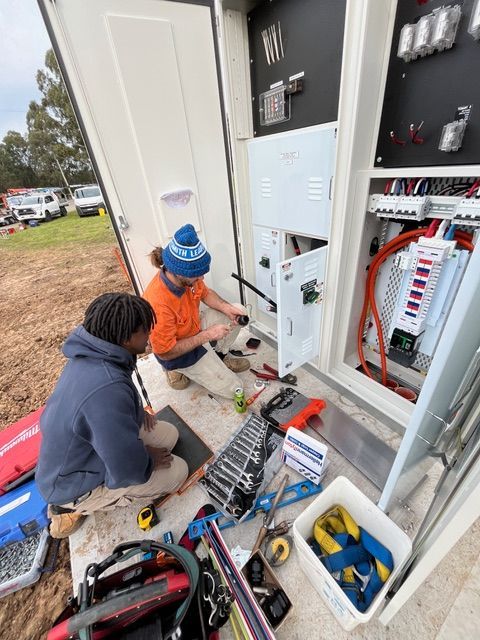 2 electricians maintaining a switchboard— Powered By JBES In Sandgate, NSW