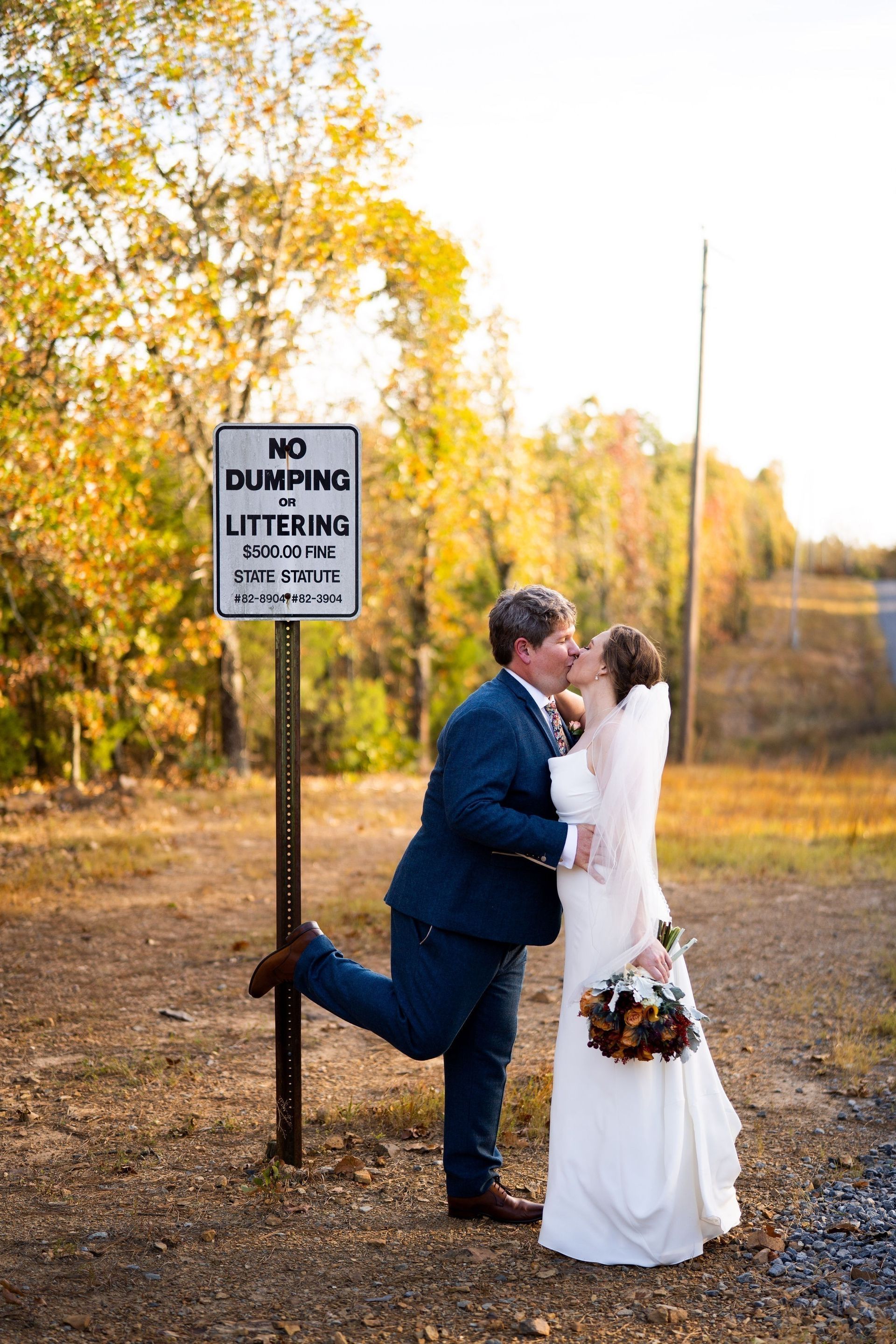 Bride and groom kissing beside a 