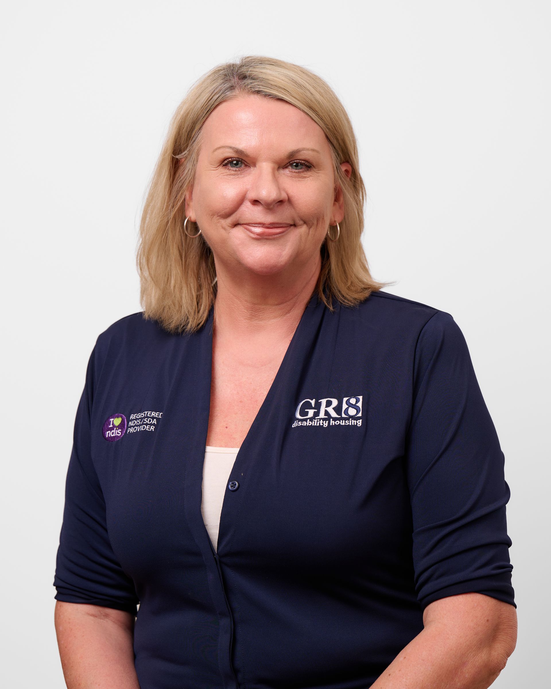 A woman wearing a blue shirt that says gbs on it