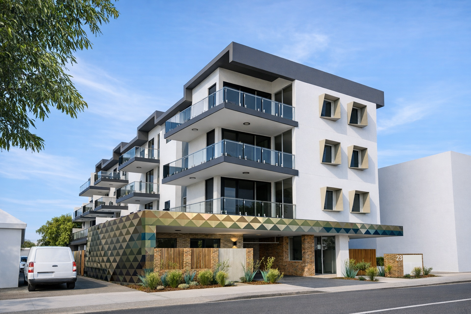 Modern, three-story apartment building with balconies, gray accents, and patterned facade at the base; sunny day.