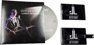 Album cover and two USB drives. Guitarist holding guitar next to CD. USB drives say 