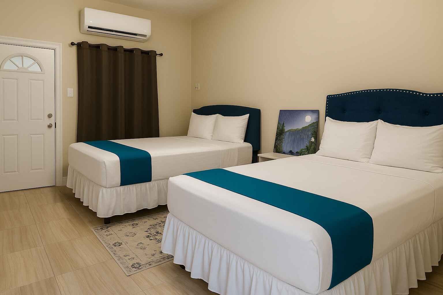 A hotel room with two beds and a window.