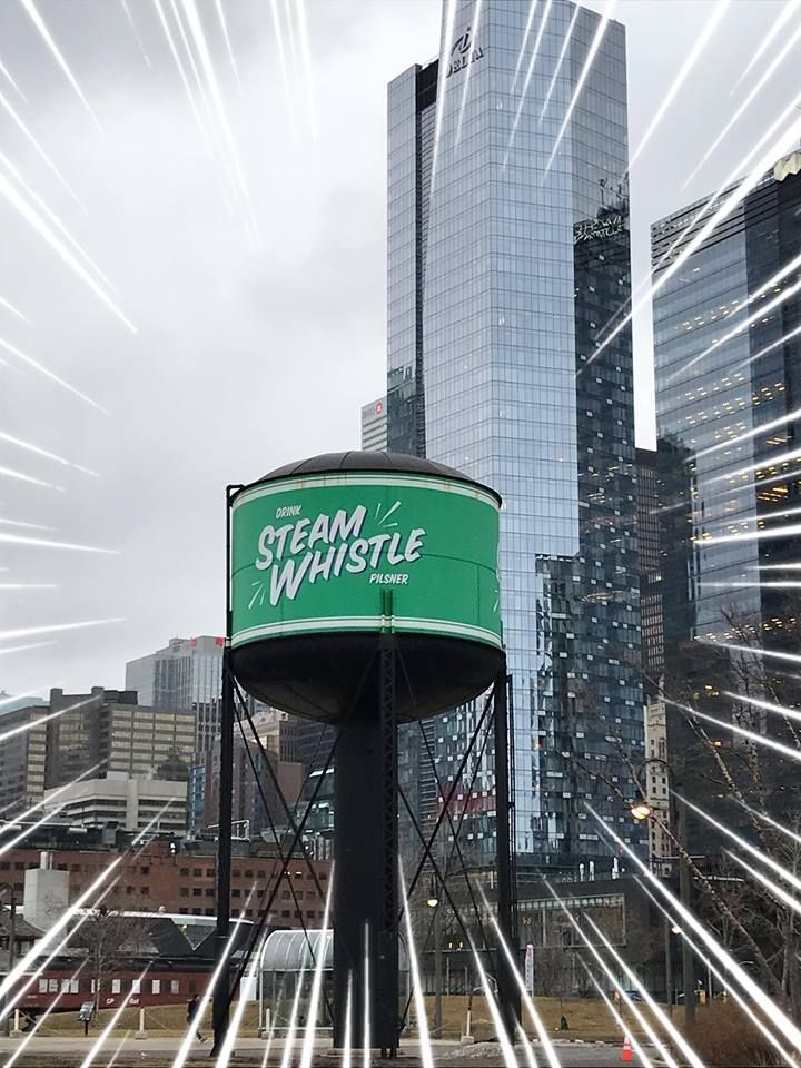 A water tower with the words steam whistle on it