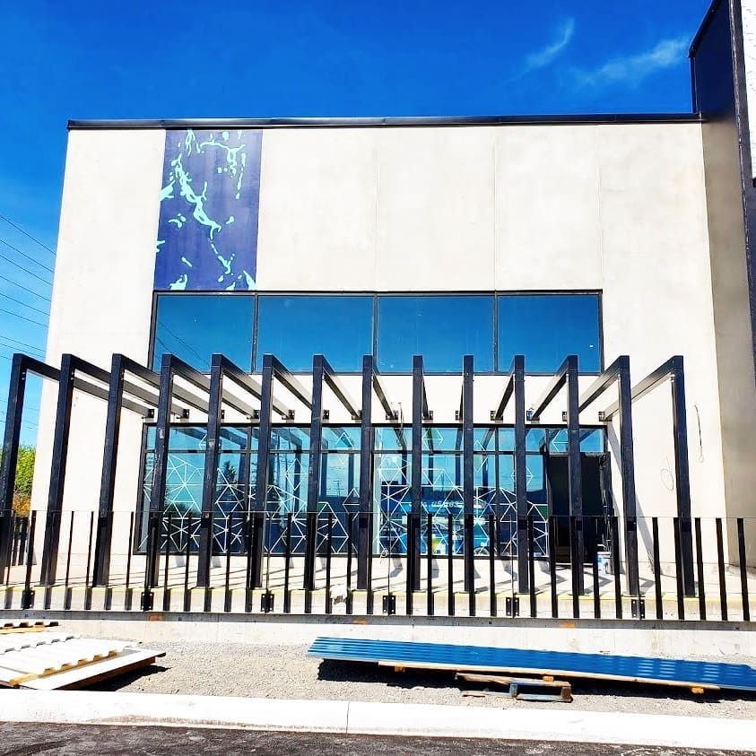 A large building with a fence in front of it
