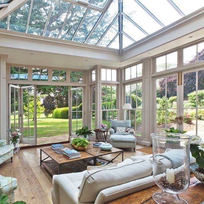 A living room with a glass ceiling and lots of windows