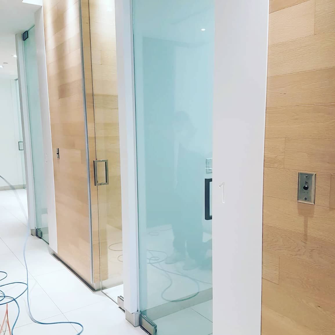 A hallway with sliding glass doors and wooden doors