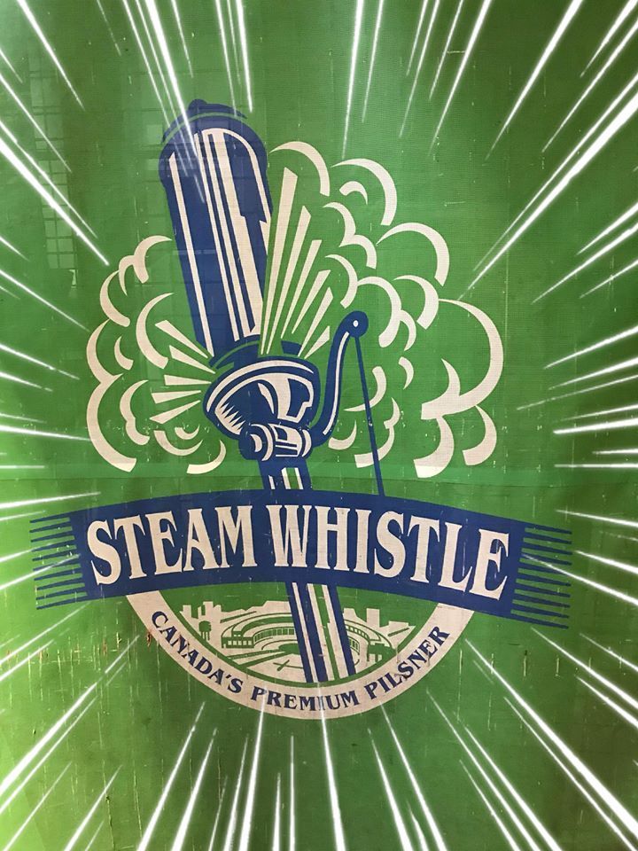 A green sign that says steam whistle canada 's premium pilsner