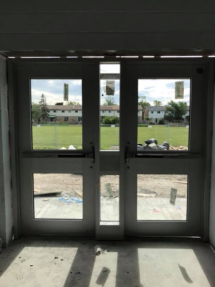 A door with a lot of windows and a view of a field.