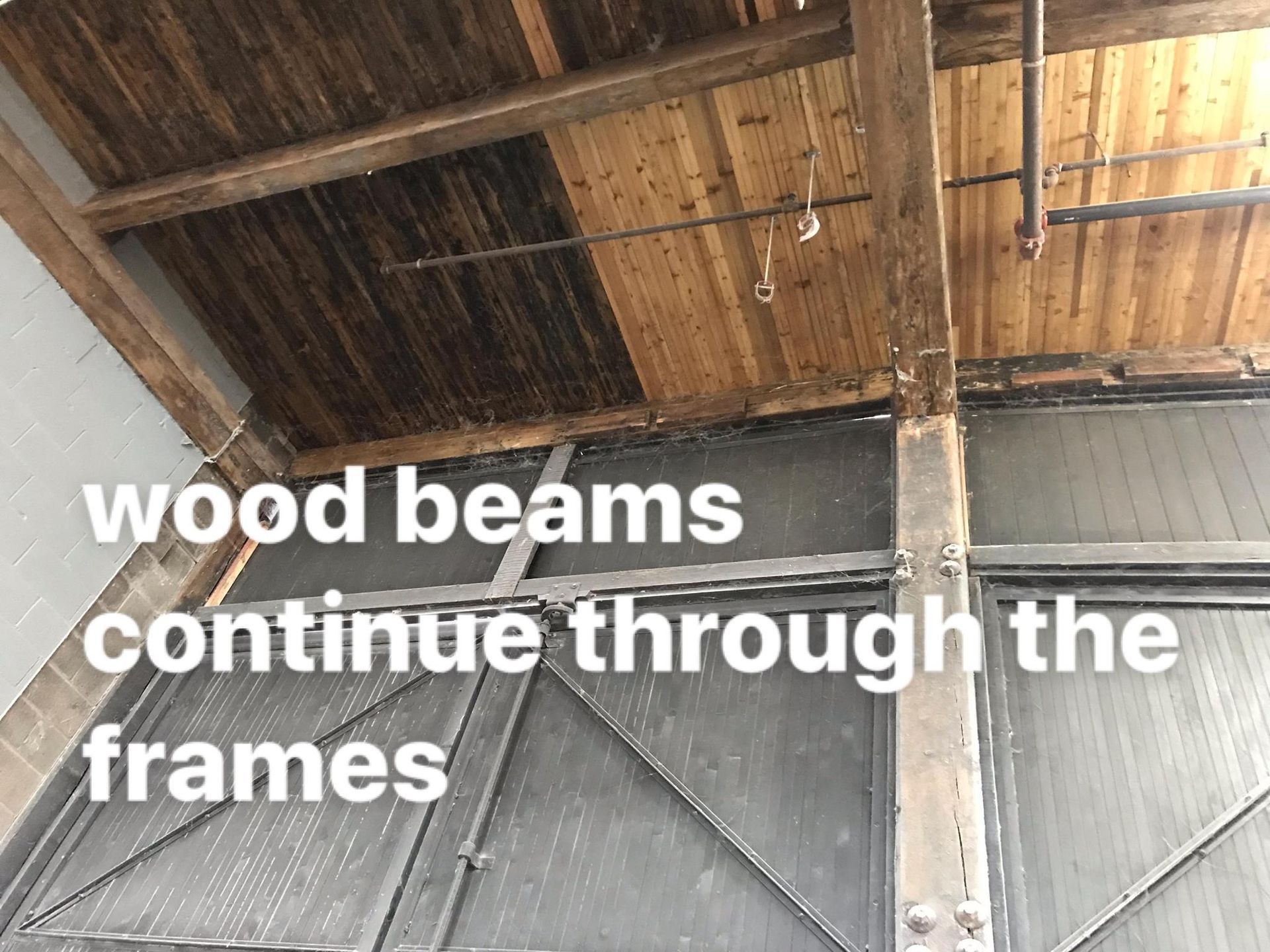 Wood beams continue through the frames of a building