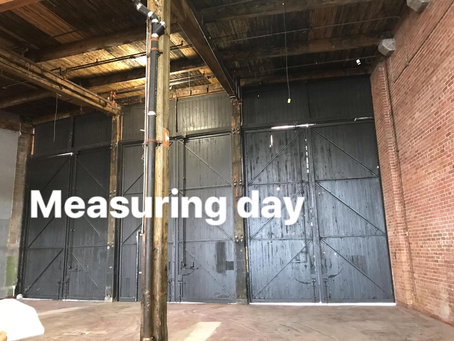 An empty warehouse with the words measuring day written on it