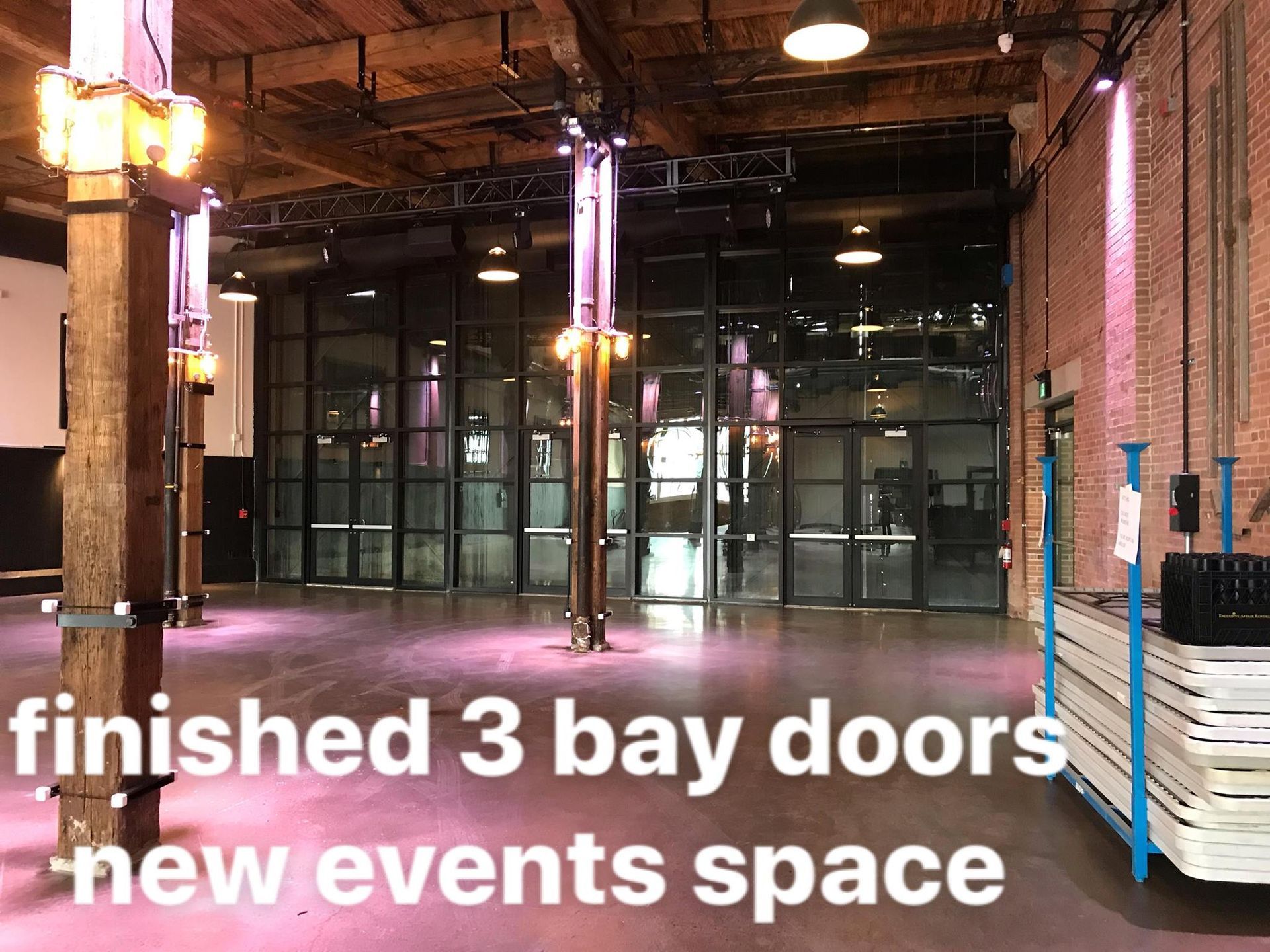 An empty room with the words finished 3 bay doors new events space