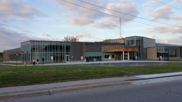 A large building with a lot of windows and a fire hydrant in front of it.