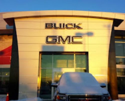 A buick gmc dealership with a truck parked in front of it