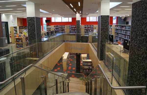 A library with stairs leading up to the second floor
