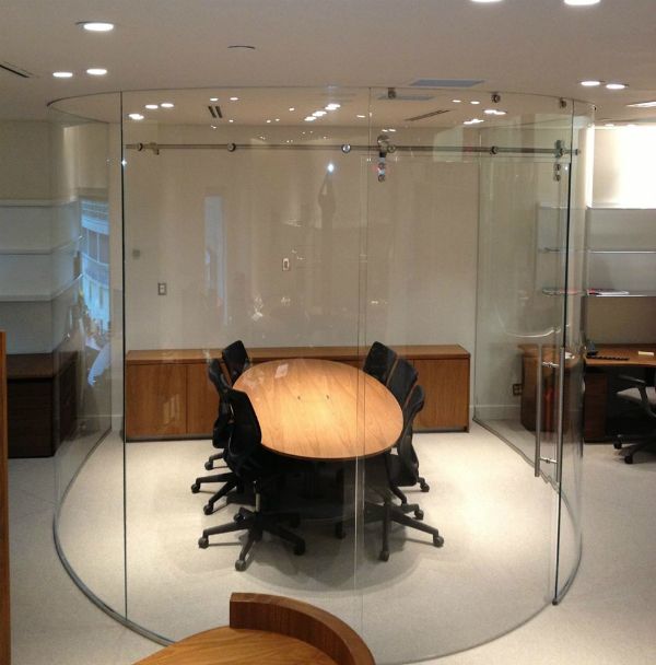 A conference room with a round table and chairs