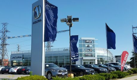 A car dealership with a lot of cars parked in front of it