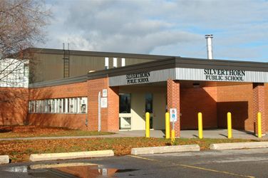 A brick building with a sign that says silverthorn public school