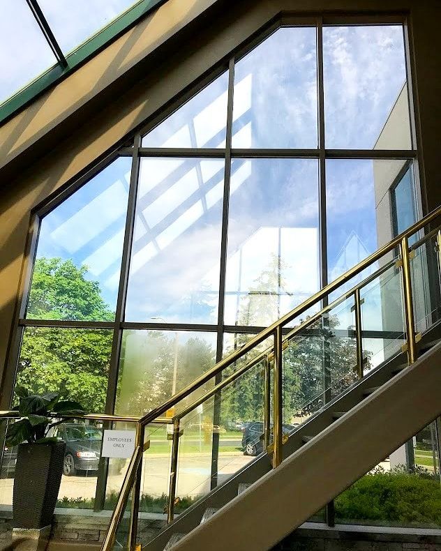 A staircase leading up to a building with a large window