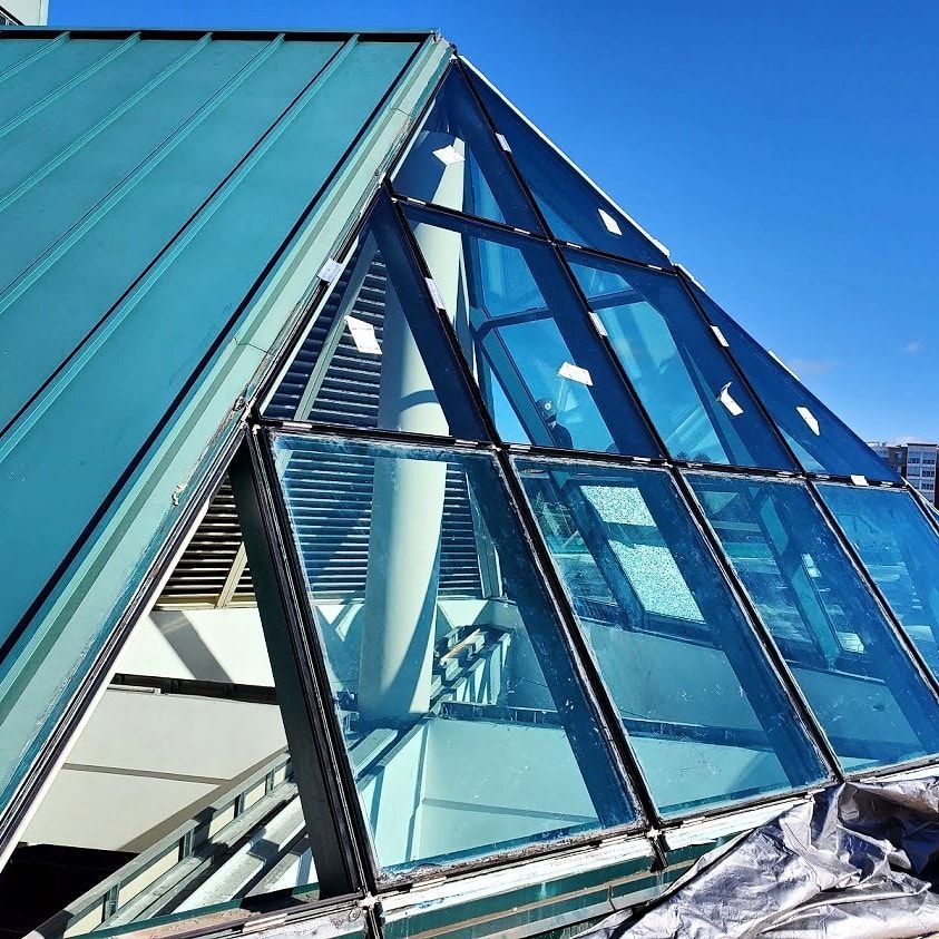A building with a pyramid shaped glass roof