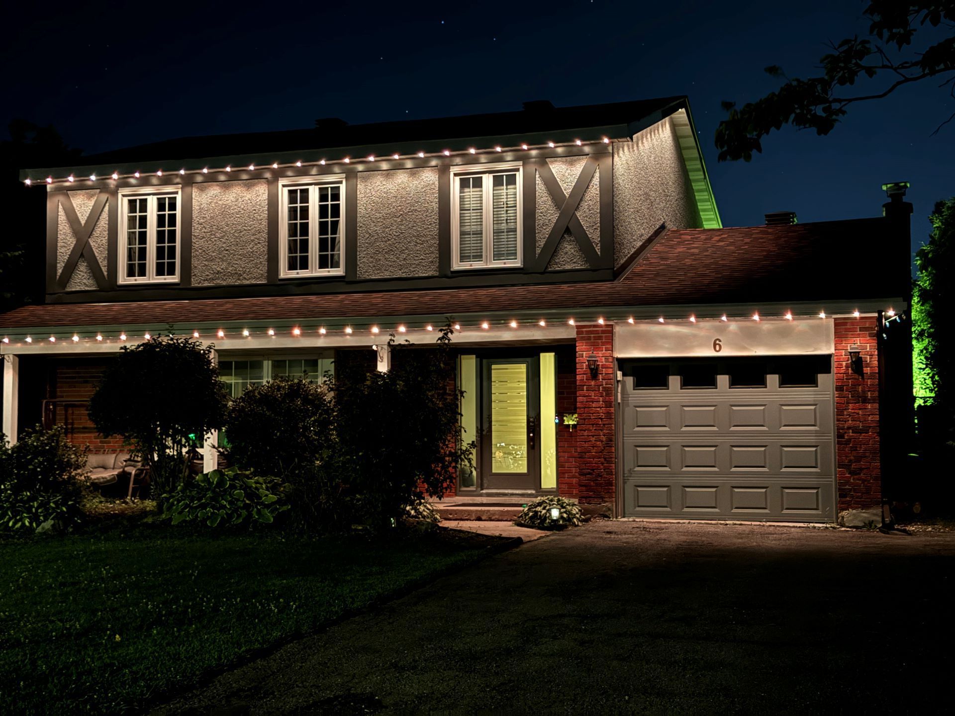 A house is lit up at night with christmas lights