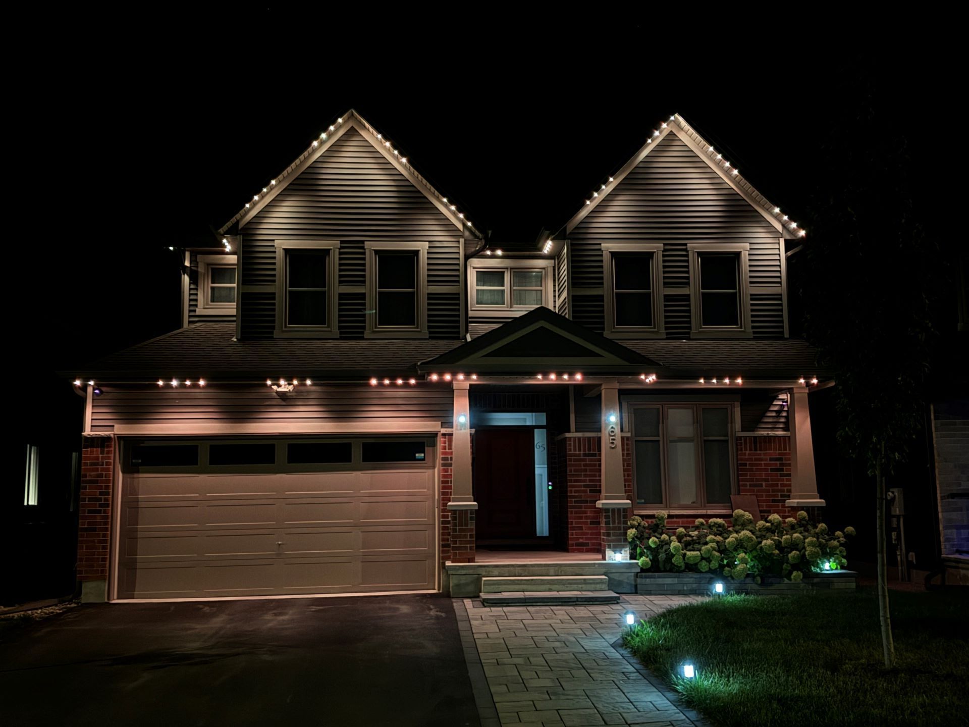 A house is lit up at night with christmas lights