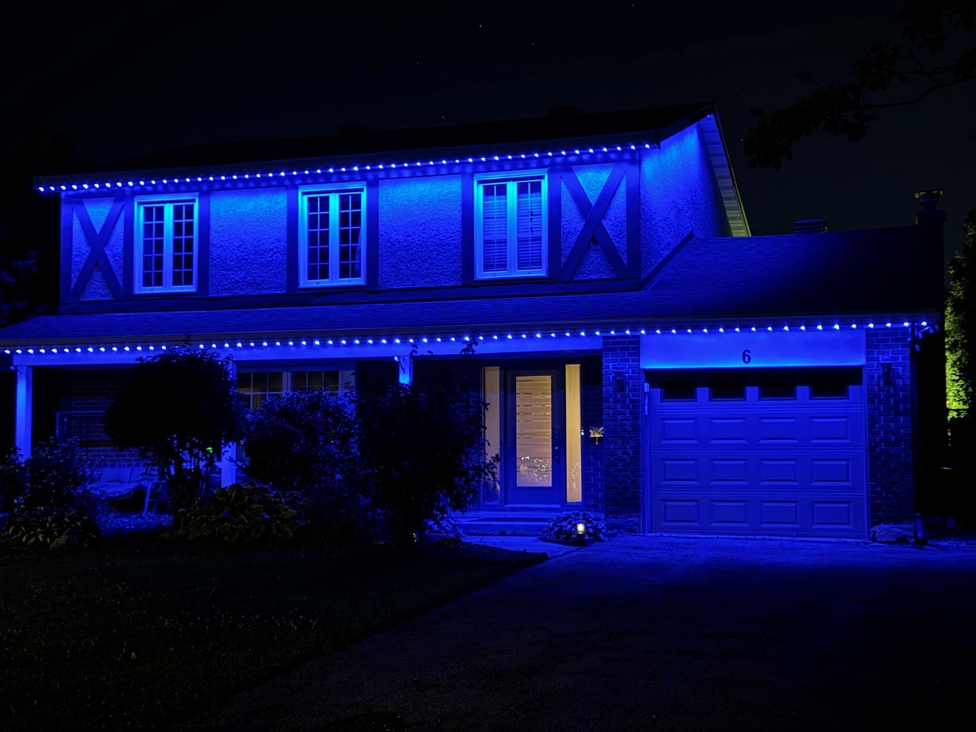A house is lit up with blue lights at night