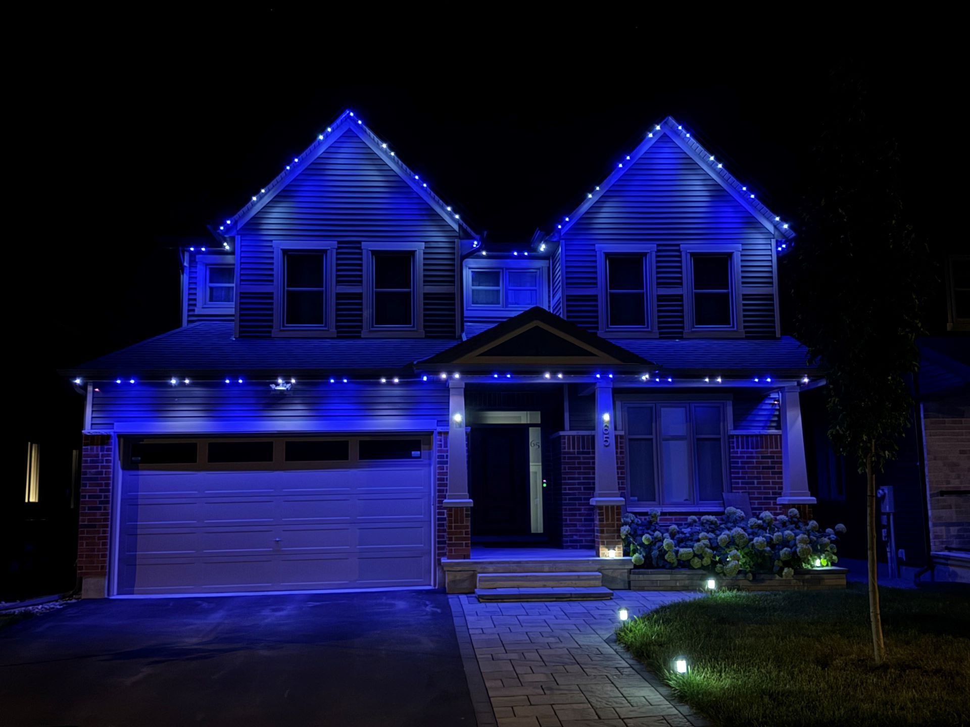 A house is lit up with blue lights at night