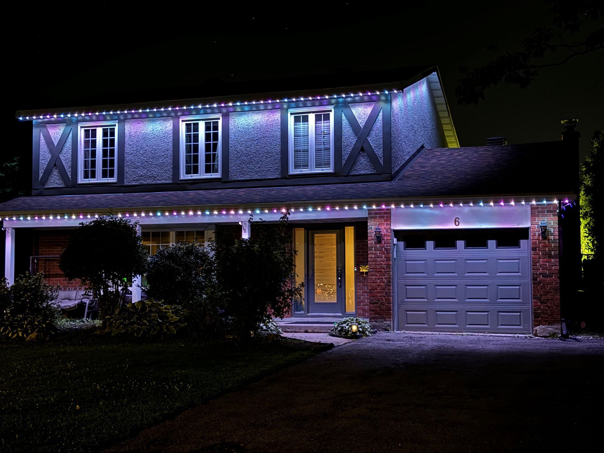 A house is lit up with christmas lights at night