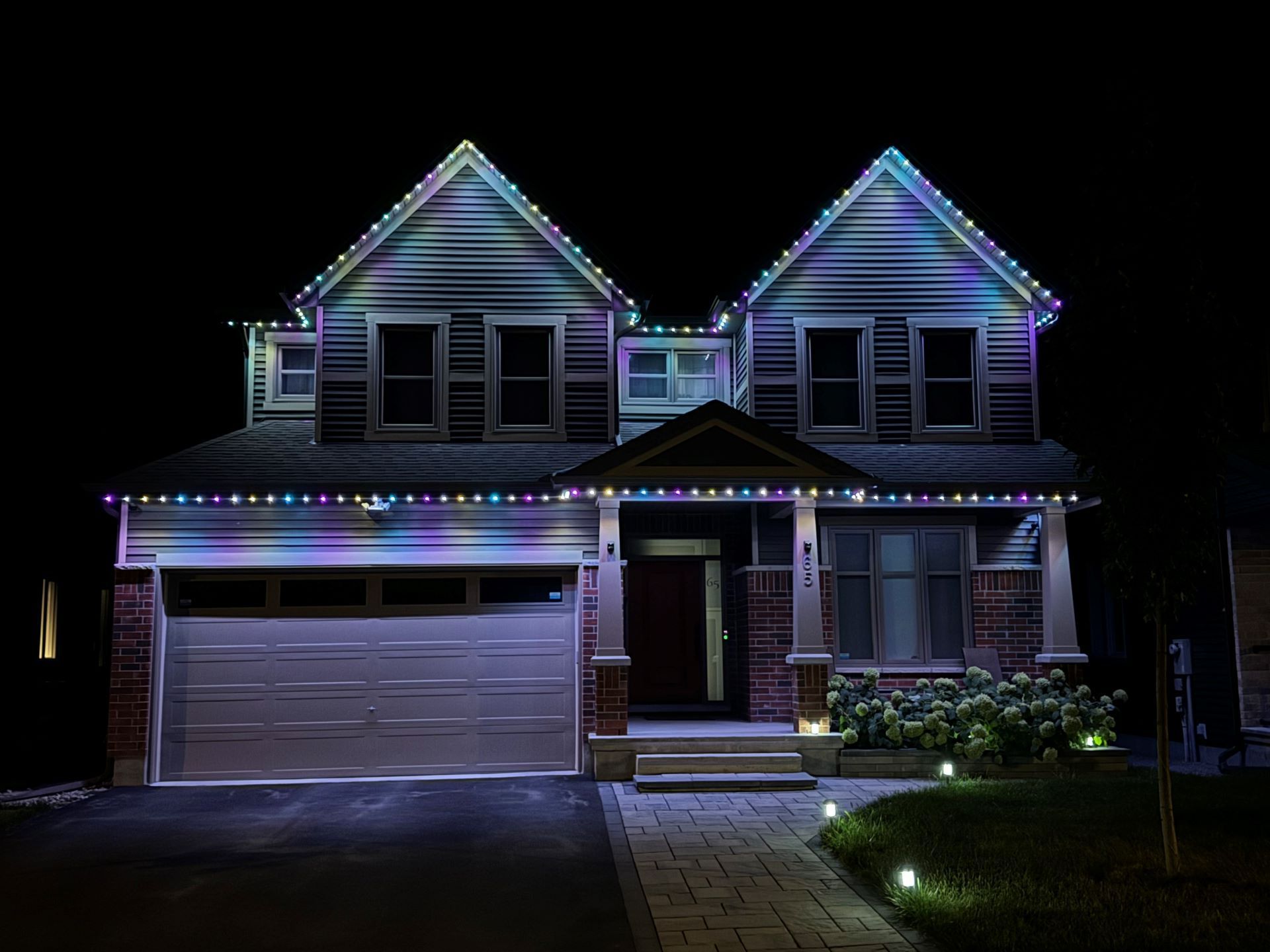 A house is lit up with christmas lights at night