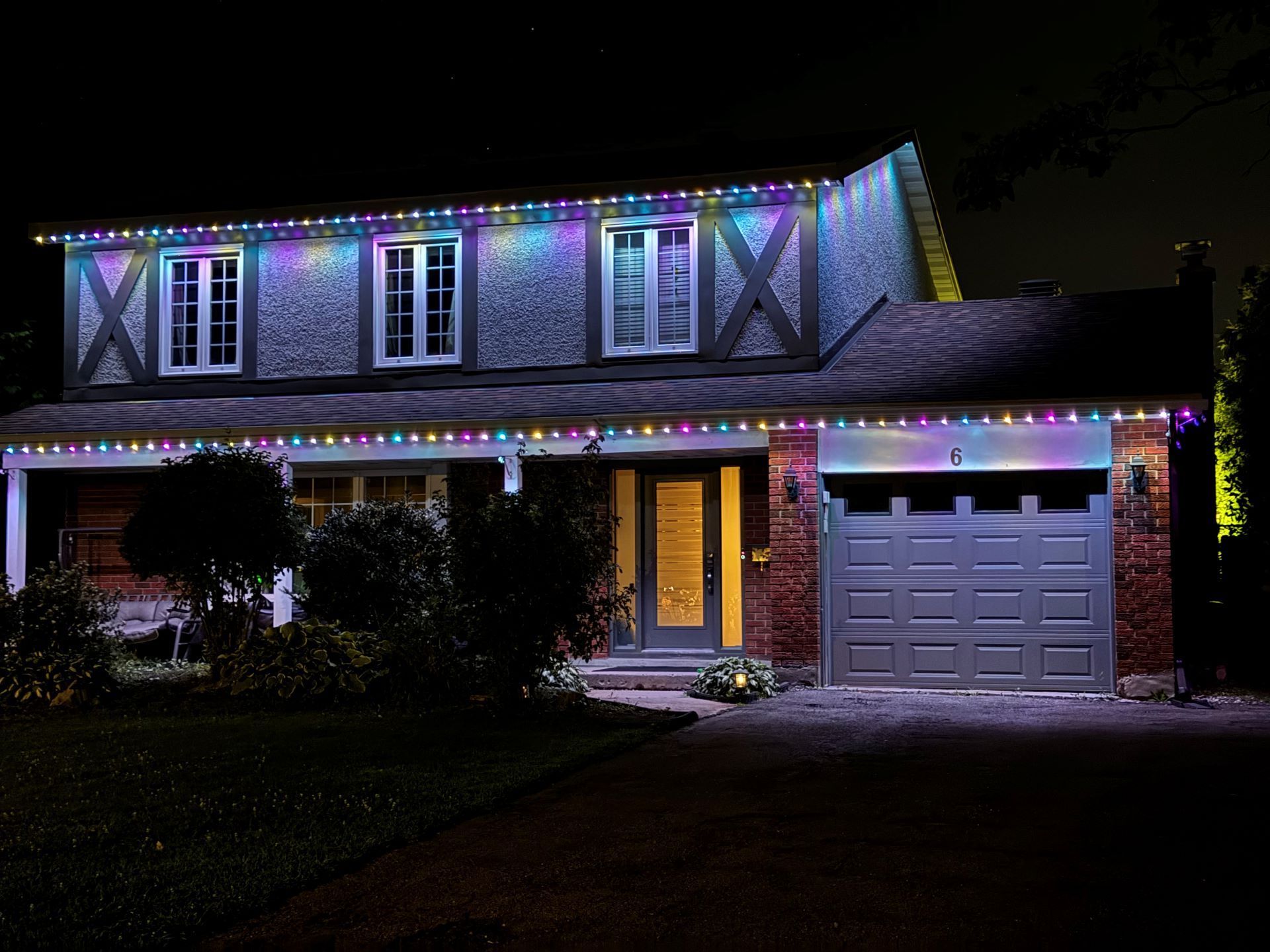 A house is lit up with christmas lights at night