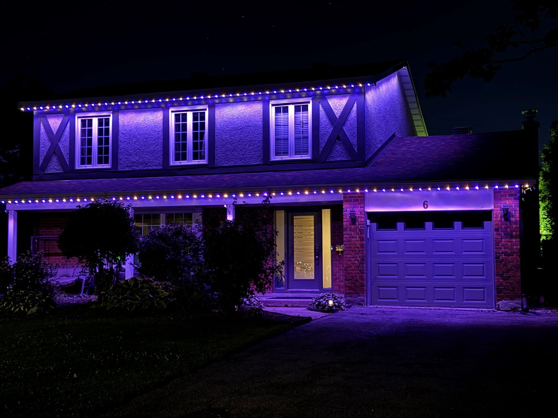 A house with purple lights on it at night