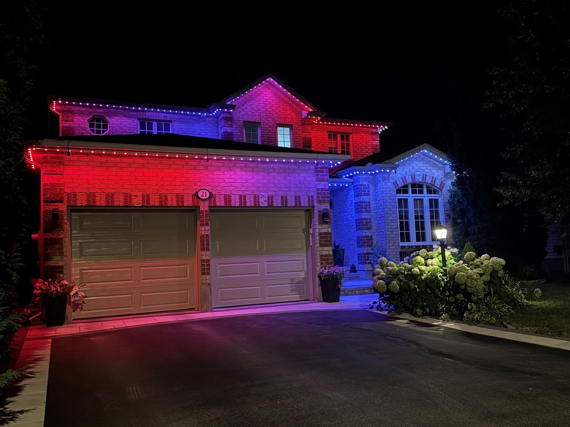 A house with red , white and blue lights on it at night.