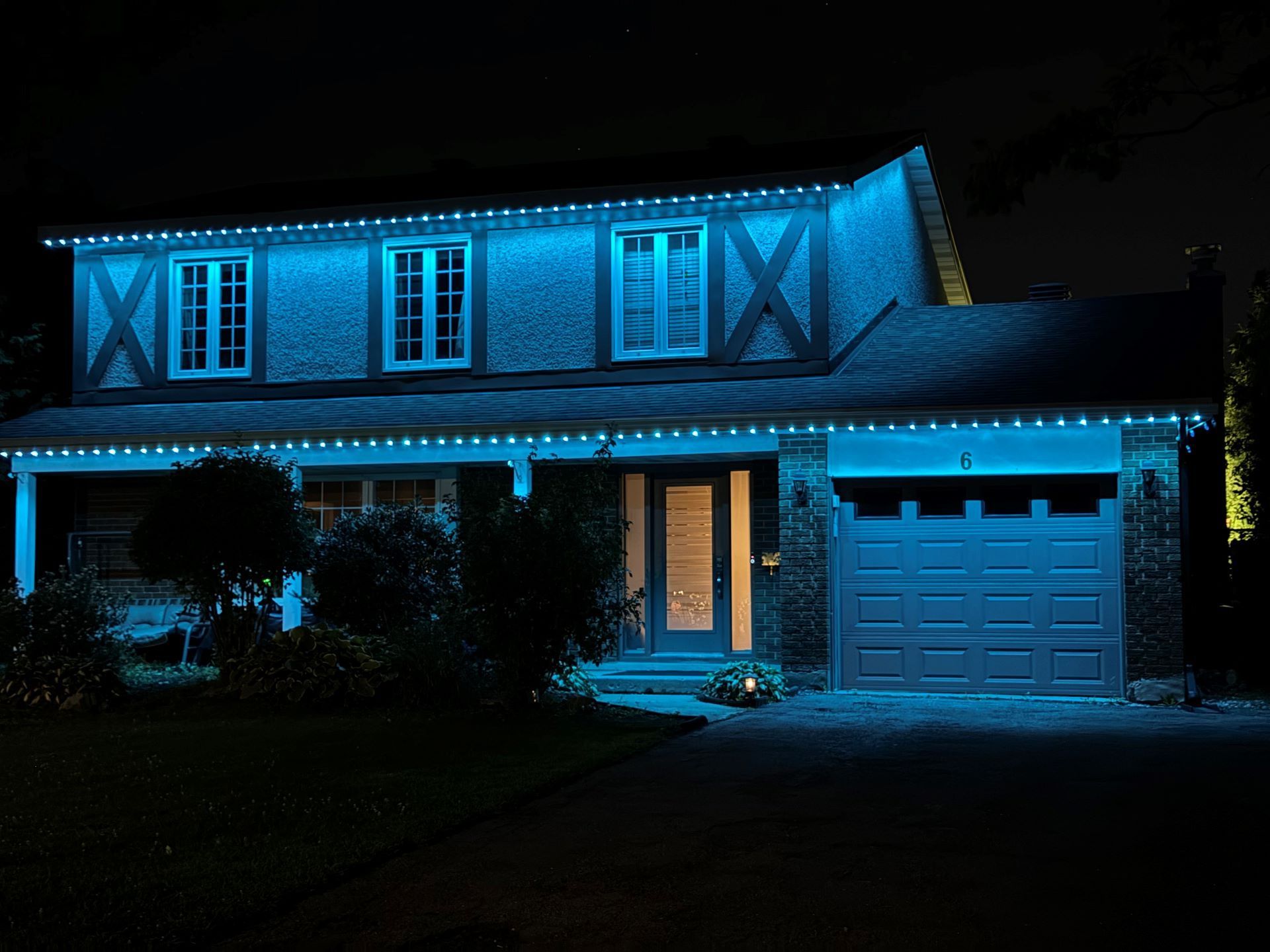 A house is lit up with blue lights at night