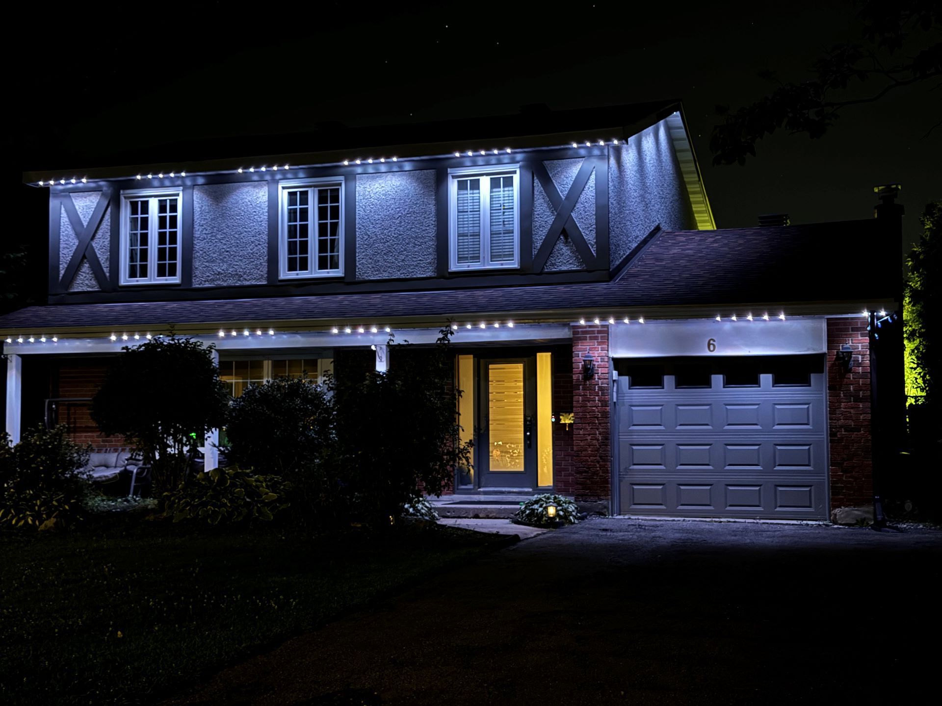 A house is lit up at night with christmas lights