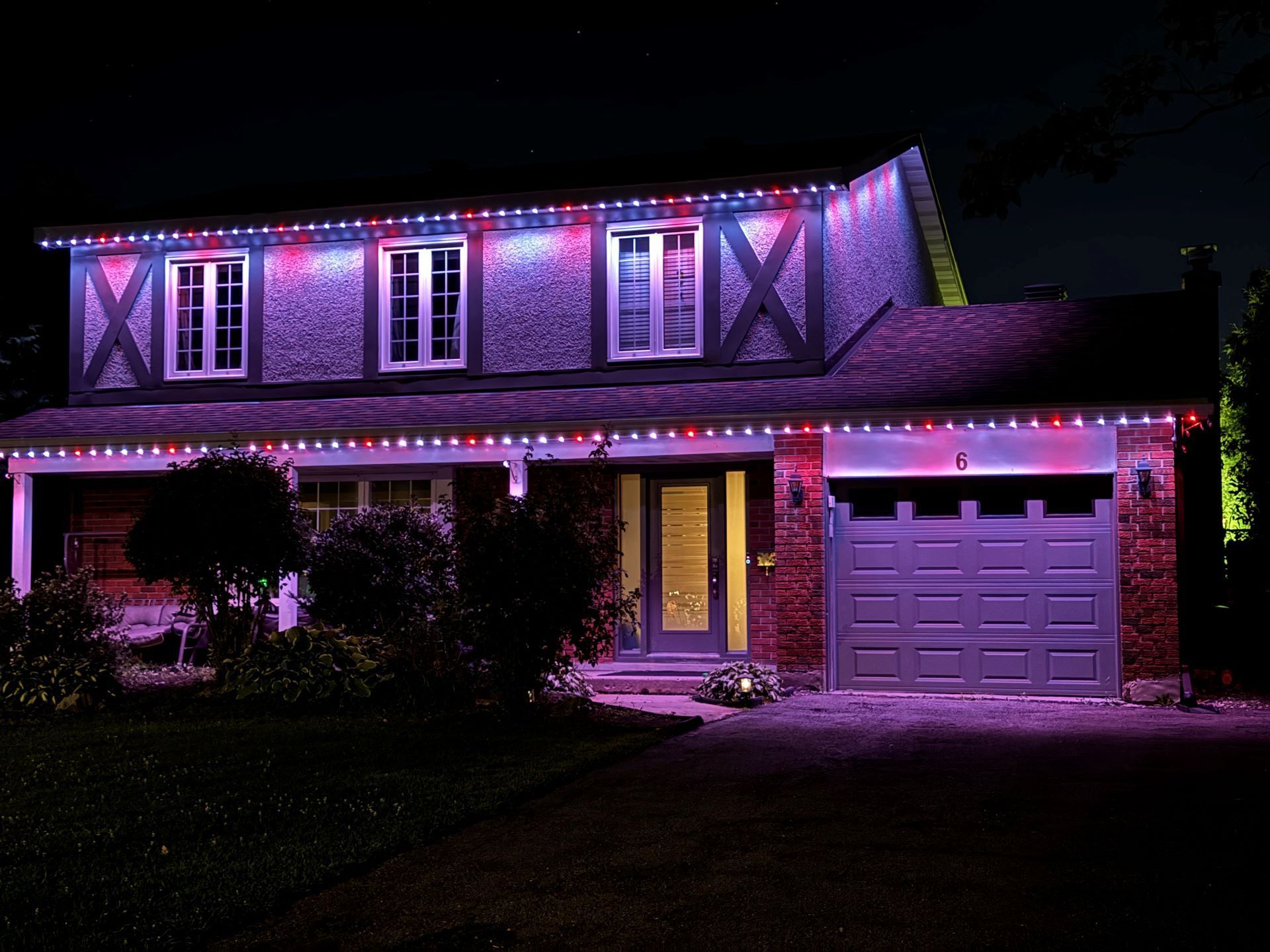 A house with christmas lights on it at night