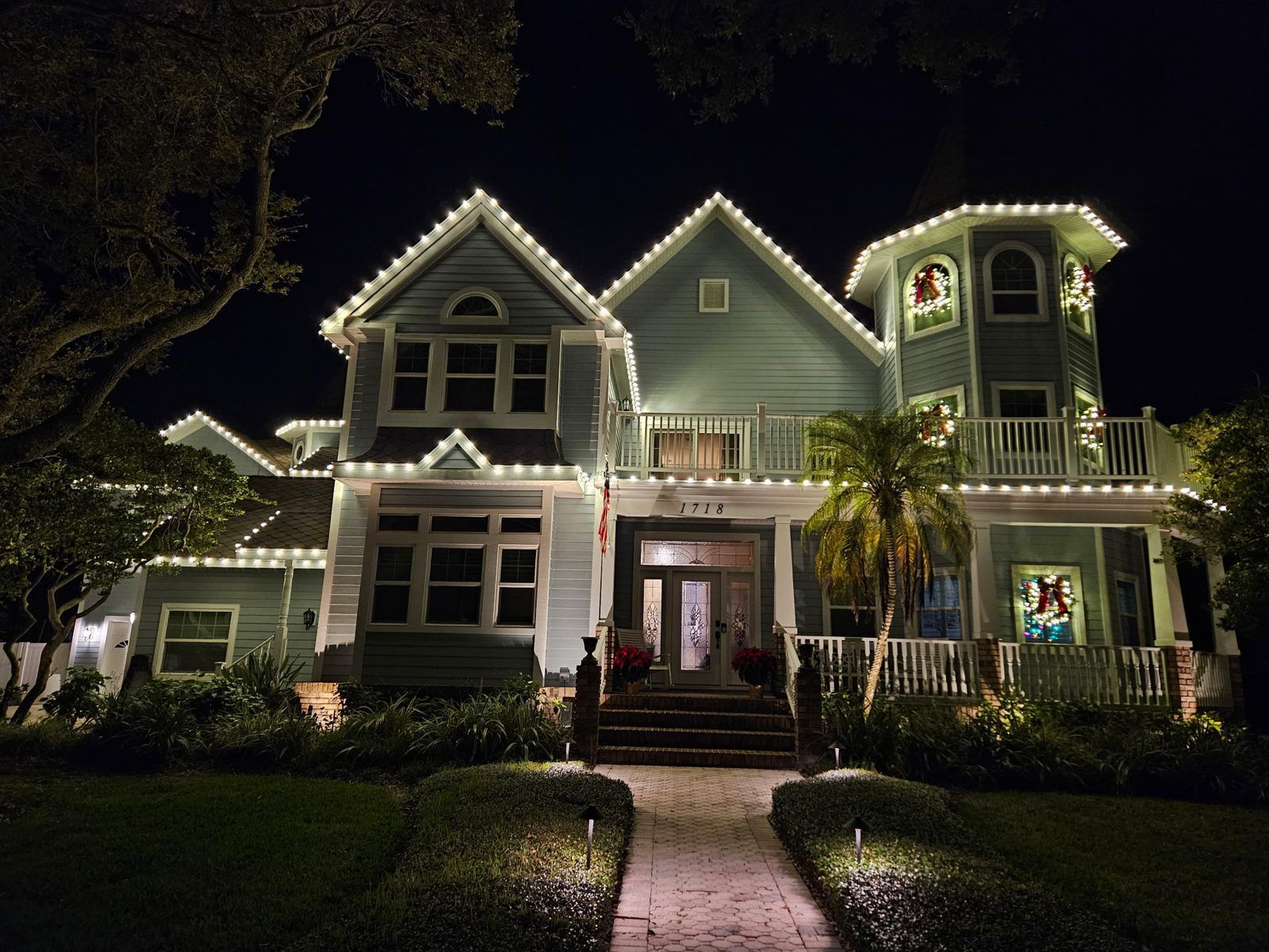 Christmas light installation with wreaths on a Tampa Bay home