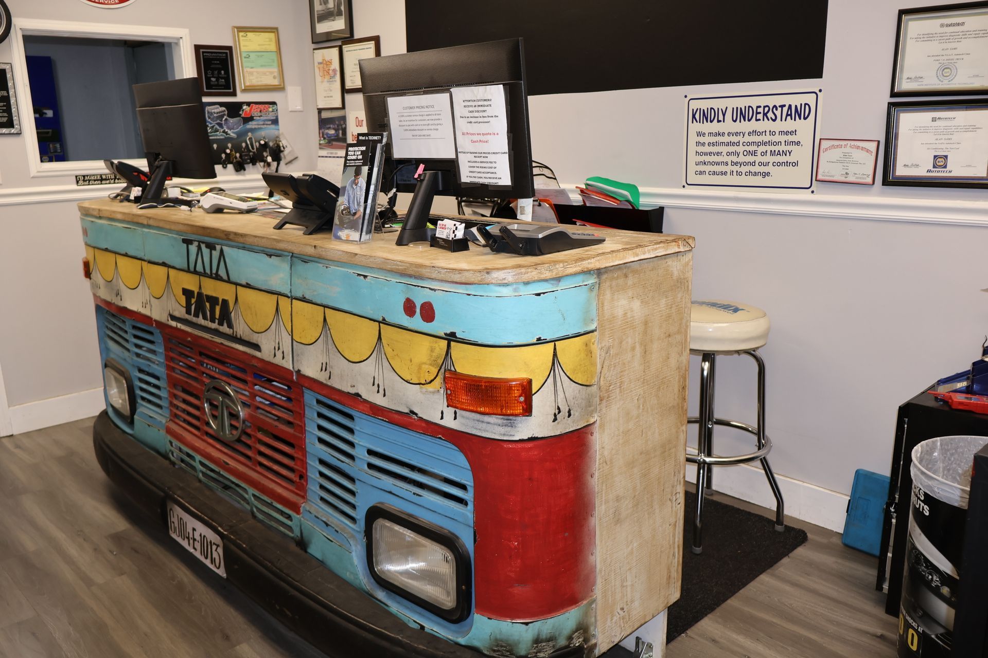 Silver pickup truck parked in driveway, surrounded by trees and lawn. Fence and houses in the background. | S&S Tire Inc & Automotive