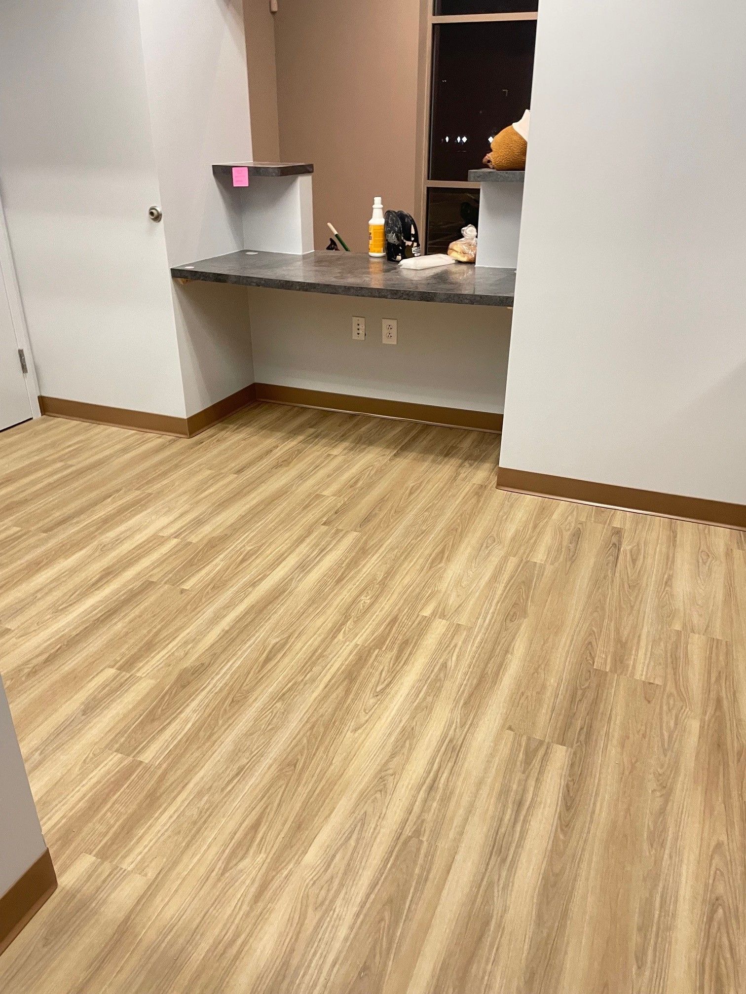 A room with a wooden floor and a counter.