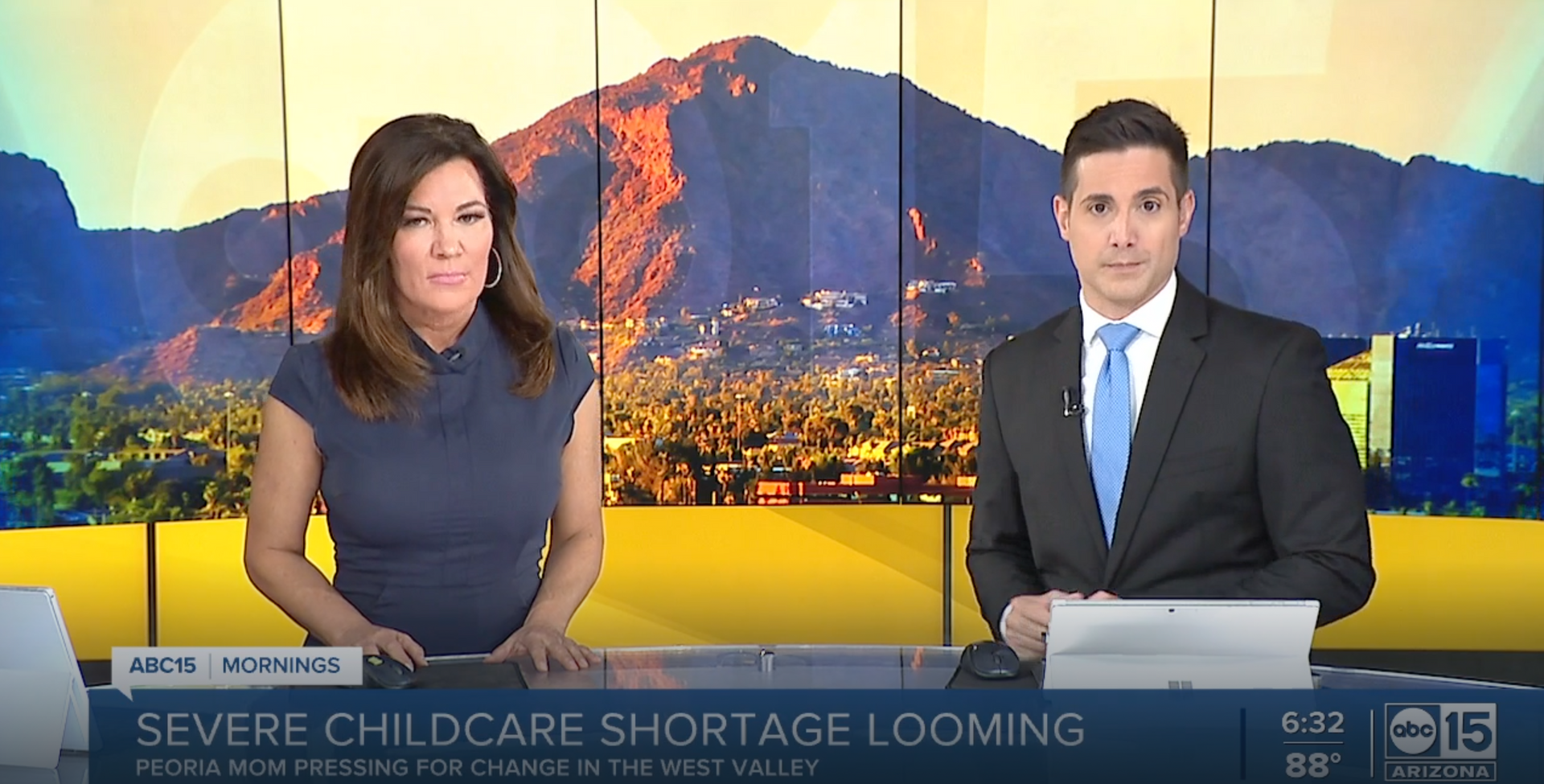 Two news anchors at a desk with a mountain city backdrop and headline: “SEVERE CHILDCARE SHORTAGE LOOMING”