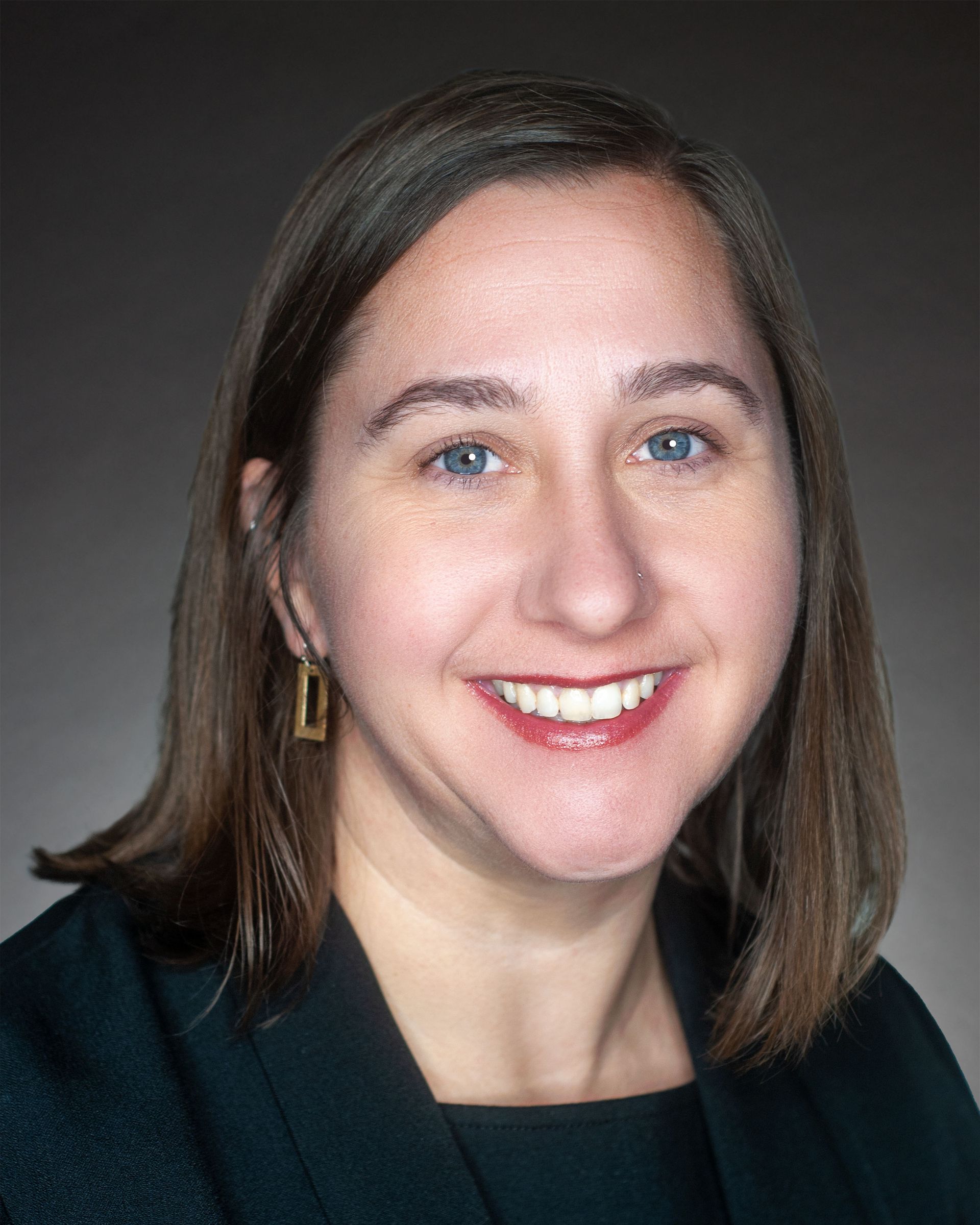 a man in a suit and tie is smiling for the camera