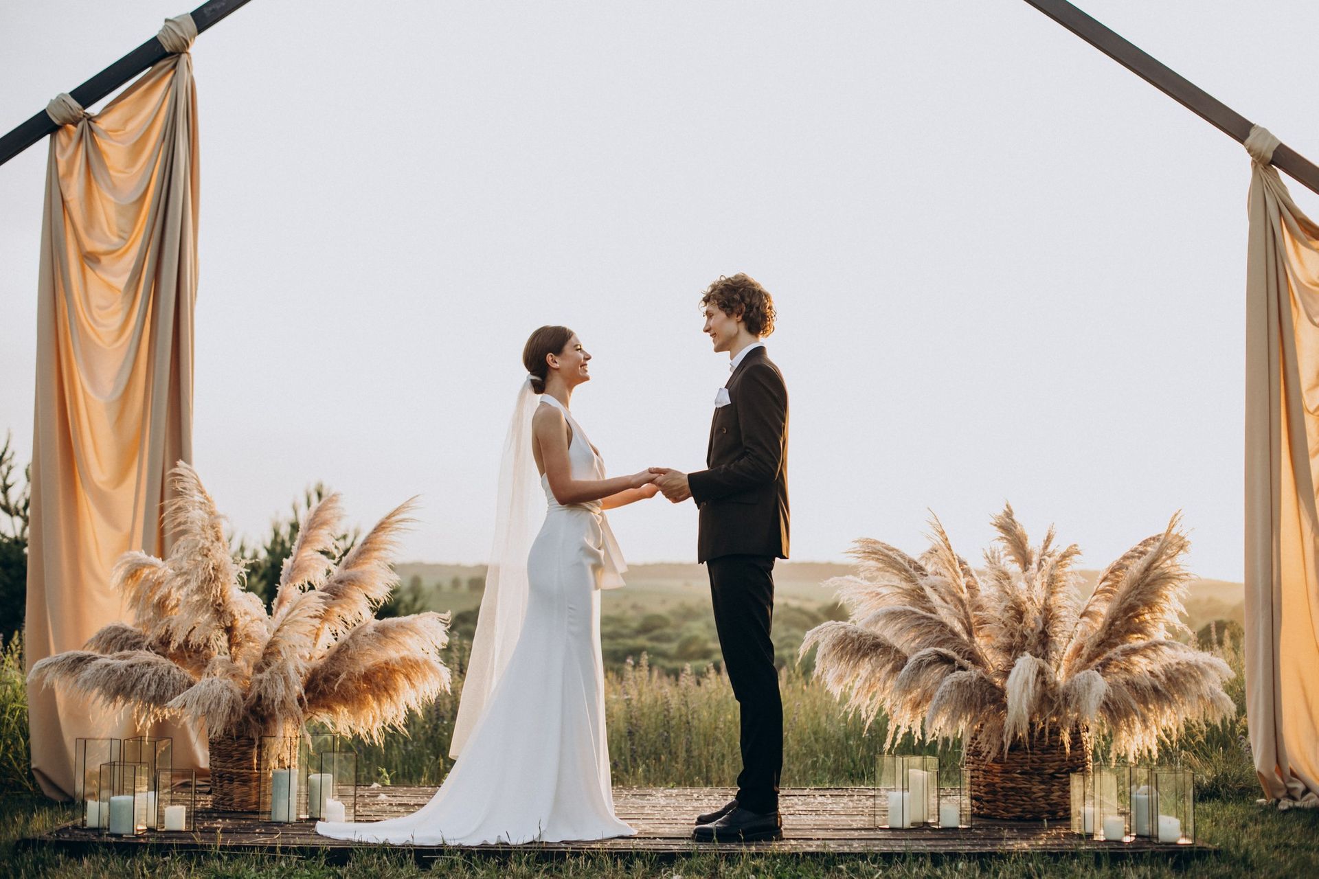 A bride and groom are holding hands during their wedding ceremony.