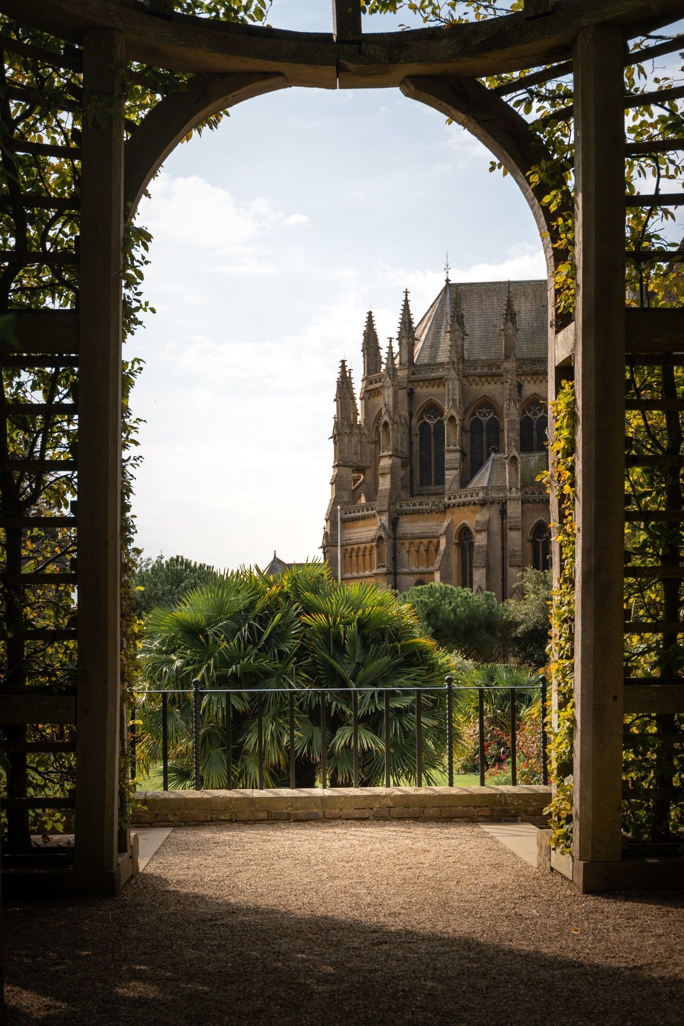 A view of a church through a wooden archway.